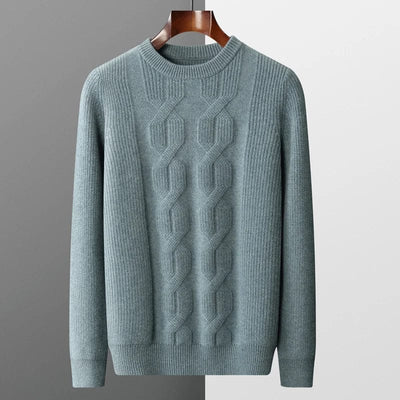 grau-kaschmirpullover-mit-kabelstrickmuster-elegant-gefaltet-auf-einem-grauen-hintergrund-neben-einer-schwarzen-uhr