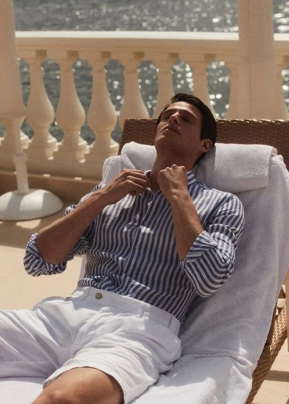 men's-striped-shirt-with-long-sleeves-design-relaxed-on-sun-lounger-mediterranean-lifestyle