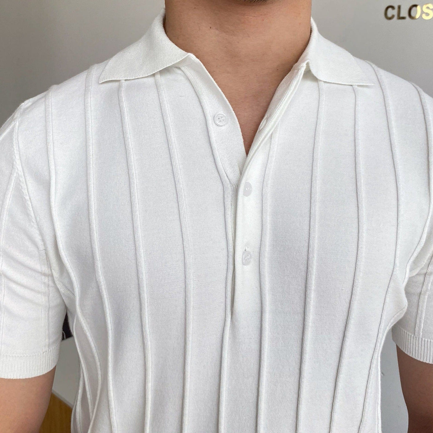 Men's-white-short-sleeved-polo-shirt-with-vertical-stripes-and-button-facing