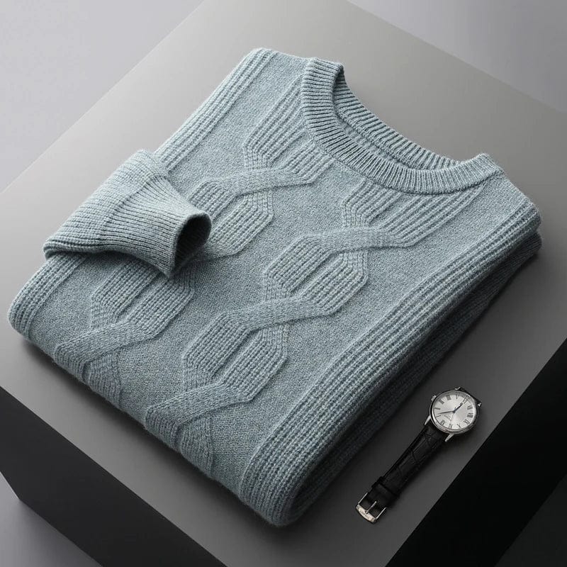 Green-cashmere-sweater-with-cable-knit-pattern-elegantly-pleated-on-a-gray-background-next-to-a-black-watch