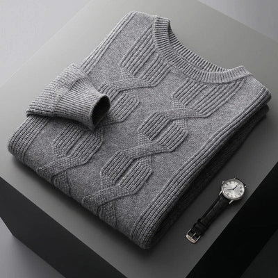 gray-cashmere-sweater-with-cable-knit-pattern-elegantly-pleated-on-a-gray-background-next-to-a-black-watch