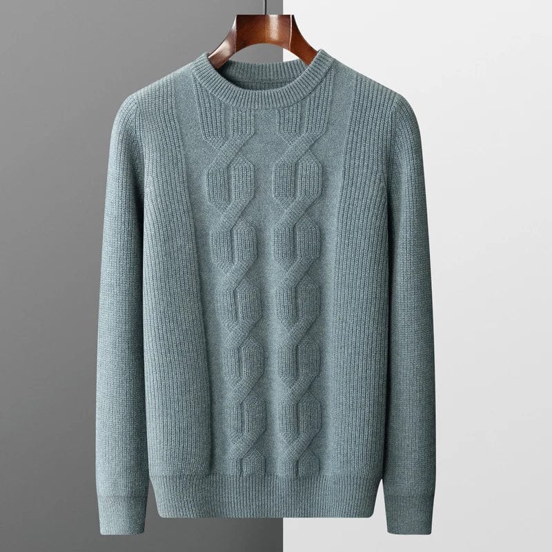 gray-cashmere-sweater-with-cable-knit-pattern-elegantly-pleated-on-a-gray-background-next-to-a-black-watch